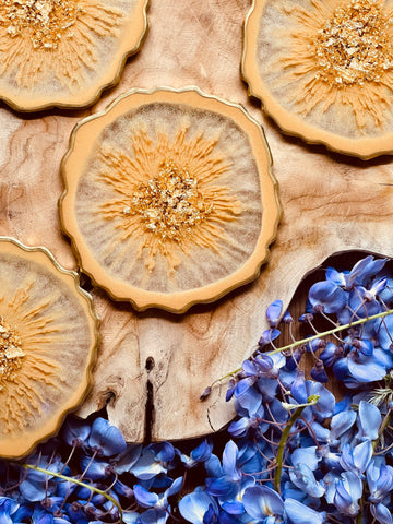 4 coasters made of resin in beige with gold