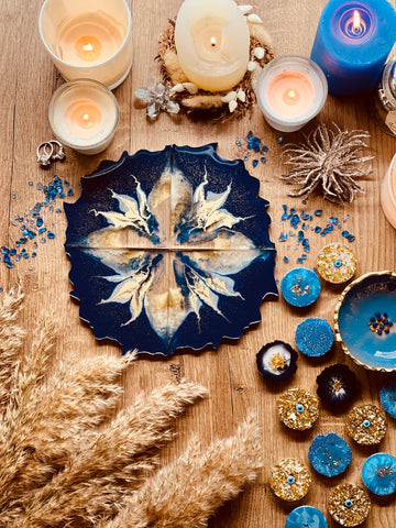 4 resin coasters in blue with gold