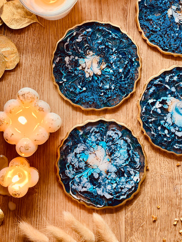 4 resin coasters in blue with gold