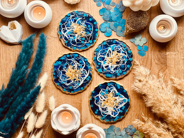 4 resin coasters in blue and white with gold